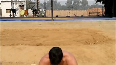 Wrestler in printed langot doing push ups