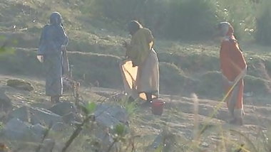 Indian granny bathing in the river
