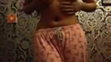 Skinny Indian woman strips in her bedroom.