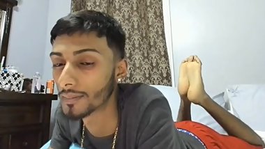 Guyanese boy playing with feet on cam